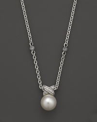 A cultured freshwater pearl is detailed in sparkling diamonds, strung on a sterling silver chain on Lagos' Luna necklace.