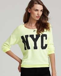 A rhinestone-bedecked NYC graphic shimmers on this highlighter-bright Vintage Havana sweatshirt. A rhinestone-bedecked NYC graphic shimmers on this highlighter-bright Vintage Havana sweatshirt.