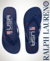 A comfortable thong sandal from Ralph Lauren is crafted with sturdy rubber straps and bold country graphics, celebrating Team USA's participation in the 2012 Olympics.