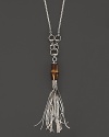 Sterling silver is a chic setting for a striking bamboo bead, horsebit detailing and a tassel. Double for drama or wear as-is. By Gucci.