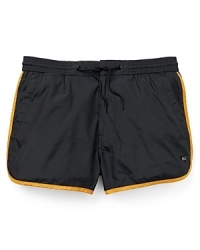 Inspired by vintage gym shorts, this playful pair of swim trunks from MARC BY MARC JACOBS offers a fun-in-the-sun design with contrast piping and a vented leg opening. Inspired by vintage gym shorts, this playful pair of swim trunks from MARC BY MARC JACOBS offers a fun-in-the-sun design with contrast piping and a vented leg opening.