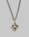 Chic little blossom accent in gleaming sterling silver and 18k gold, centered with a smooth cabochon blue topaz stone. Chain sold separately About ½W X ¾H Imported