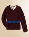 A wide ribbed texture and a contrast ribbon with a bow give this merino wool sweater its pretty panache.Round ribbed necklineLong sleeves with ribbed cuffsContrast attached self beltButton placketWide ribbed hemMerino woolDry cleanImported Please note: Number of buttons may vary depending on size ordered. 