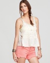 Beading and neon embroidery embellish an ivory cotton Free People tank flaunting a playful peplum--the whimsical addition to your summer wardrobe the balmy season is wanting for.