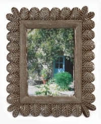 Get nesting. Hand cut and hammered in recycled steel by artist Rony Jacques, this rustic picture frame displays your favorite people and places between rows of beautiful songbird feathers. Once the hammered detail is complete, each is varnished and dried in the hot Caribbean sun. Get nesting. Hand cut and hammered in recycled steel by artist Rony Jacques, this rustic picture frame displays your favorite people and places between rows of beautiful songbird feathers. Once the hammered detail is complete, each is varnished and dried in the hot Caribbean sun.