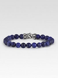 Rugged, lightly-textured lapis beads stand in stark contrast to the bracelet's hand-forged, sterling silver clasp. Beads, 8mm Length, about 8½ Lobster clasp Made in USA 