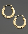 An elegant twist on the classic hoop. 18k gold hoop earrings with a pretty textured design for a more modern look. 8
