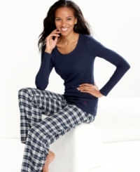 Relax in complete comfort in these pajamas by Nautica. The scoop neck maritime top features an anchor logo on the lower corner of the shirt, while the roomy pants feature contrasting satin lining on the inside of the elastic waistband.