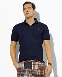 Short-sleeved polo shirt, cut for a comfortable, classic fit in breathable mercerized Pima cotton mesh for a handsome luster. Short-sleeved polo shirt, cut for a comfortable, classic fit in breathable mercerized Pima cotton mesh for a handsome luster.