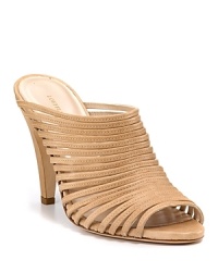 Slim leather straps arch over these high-heeled sandals. Wear to toughen up a sweet sundress--or try with cuffed denim. Slim leather straps arch over these high-heeled sandals. Wear to toughen up a sweet sundress--or try with cuffed denim.