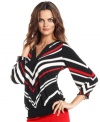 A bold chevron stripe gives this Alfani top a dynamic look, while a smocked hem lends a fabulous fit.