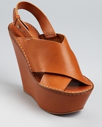 Chloé brings their luxe leather and simplistic-chic aesthetic to a chunky slingback silhoeutte, finished with a tall, covered wedge and ample platform. Chloé brings their luxe leather and simplistic-chic aesthetic to a chunky slingback silhoeutte, finished with a tall, covered wedge and ample platform.