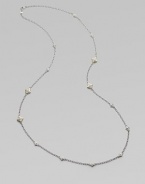 From the Windsor Collection. A long and lovely chain of textured oval links is sprinkled with shapely little medallions sparked white sapphires. White sapphires Sterling silver and 18k yellow gold Length, about 34 Lobster clasp Imported