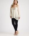Featuring incredible embroidered details, this airy tunic offers a relaxed fit that you will love. Self-tie necklineLong sleevesStunning embroidery on front and backBack yokePull-on styleAbout 34 from shoulder to hemRayonMachine washImported