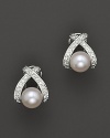 Classic cultured pearls are channel-set in an X design.
