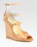 Shiny patent leather forms this lifted silhouette, with three adjustable straps and an open toe. Self-covered wedge, 4½ (115mm)Patent leather upperThree adjustable strapsLeather lining and solePadded insoleMade in Italy