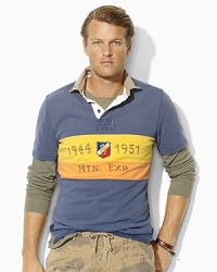 Rendered in rustic utility cotton for a vintage feel, a trim-fitting rugby shirt boasts an exploration-driven design with rugged patchwork and bold pieced stripes. Rendered in rustic utility cotton for a vintage feel, a trim-fitting rugby shirt boasts an exploration-driven design with rugged patchwork and bold pieced stripes.