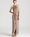 Golden chainlink details lend a luxe look to BCBGMAXAZRIA's long and lean dress--team with chunky bangles for a look that's going places.