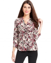 Alfani's top is outfitted in a bold print and ruched for a flattering fit. Alfani's top is outfitted in a bold print and ruched for a flattering fit.