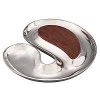 A dramatic interplay of swirling curves, this cheese-and-cracker server offers a feast for the eye as well as the appetite. Dense, durable, and naturally resinous, acacia will not absorb stains or odors. Signature Nambé alloy combines eight different metals and polishes to a silver-like luster. Designed by Karim Rashid, as part of the contemporary Morphik collection of serving/entertaining accessories that feature the curving forms nature favors. A dramatic interplay of swirling curves, this cheese-and-cracker server offers a feast for the eye as well as the appetite. Dense, durable, and naturally resinous, acacia will not absorb stains or odors. Signature Nambé alloy combines eight different metals and polishes to a silver-like luster. Designed by Karim Rashid, as part of the contemporary Morphik collection of serving/entertaining accessories that feature the curving forms nature favors.