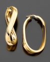 Lovely 14k gold oval hoop earrings spiced up with a twist. Length 2.