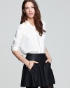 Featuring a darling peter-pan collar and nape-to-hem back buttons, this Free People top exudes girlish charm.