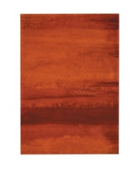Abstract and dramatic, this handcrafted wool rug features a rich spectrum of shades from burnt orange tones to deep reds. The ethereal coloration pattern is reminiscent of a vivid sky at sunset. Luster-wash finish creates gently-diffused color variation. Abstract and dramatic, this handcrafted wool rug features a rich spectrum of shades from burnt orange tones to deep reds. The ethereal coloration pattern is reminiscent of a vivid sky at sunset. Luster-wash finish creates gently-diffused color variation.