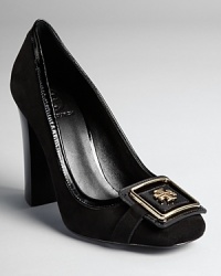 A squared logo plate lends a 60s feel to Tory Burch's retro-inspired Julian pumps, dressed up with patent piping. A squared logo plate lends a 60s feel to Tory Burch's retro-inspired Julian pumps, dressed up with patent piping.