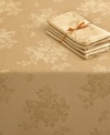 Elegance with an autumnal twist. Featuring a leafy damask pattern in radiant gold, this Homewear round tablecloth outfits harvest tables in seasonal splendor. (Clearance)