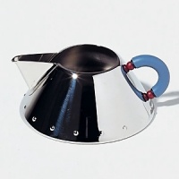 This creamer by Michael Graves in polished steel has contrast handle. White has matching kettle and mugs to create a complete chic set. This creamer by Michael Graves in polished steel has contrast handle. White has matching kettle and mugs to create a complete chic set.