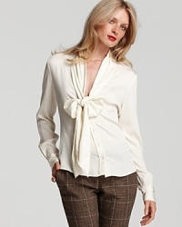 Exude office elegance in Rachel Zoe's chic v neck blouse, flaunting a bow-tie collar and rounded hem for refined femininity. Exude office elegance in Rachel Zoe's chic v neck blouse, flaunting a bow-tie collar and rounded hem for refined femininity.