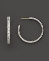 Pavé gems add glitter to classic sterling silver hoop earrings.