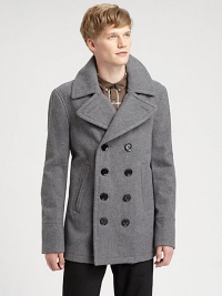 A traditional double-breasted silhouette completes the winter warmth of this handsome overcoat, shaped in a supremely-soft wool blend for a fit and feel that is timeless.Button-frontSide slash pocketsAbout 31 from shoulder to hem90% wool/10% nylonDry cleanImportedThis style runs true to size. We recommend ordering your usual size for a standard fit. 