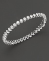 Classic elegance, a diamond bezel tennis bracelet in white gold.