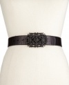 Ornate and eye-catching, this sleek leather belt from Fossil is topped with an intricately sculpted buckle, adorned with rhinestone embellishments.