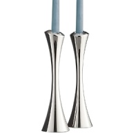 Nambé Aquila candlesticks. Sculptural and free flowing, a gently turning spiral distinguishes the pieces in this collection, created by celebrated designer Lou Henry for Nambé. Introduced in Spring 2008, these tall slender candlesticks are perfectly crafted of Nambé signature alloy. A great set at the dinner table when paired with matching Aquila dinnerware, they also stand in bold confidence all on their own. Nambé Aquila candlesticks. Sculptural and free flowing, a gently turning spiral distinguishes the pieces in this collection, created by celebrated designer Lou Henry for Nambé. Introduced in Spring 2008, these tall slender candlesticks are perfectly crafted of Nambé signature alloy. A great set at the dinner table when paired with matching Aquila dinnerware, they also stand in bold confidence all on their own.