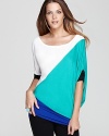 This BCBGMAXAZRIA top approaches style from a different angle, with diagonal color blocking and side draping that's right on.