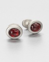 Oval shaped cuff links for the gentleman who commands attention, set in luminous sterling silver set with simulated garnet.Sterling silverGarnetAbout .88 diam.Made in USA