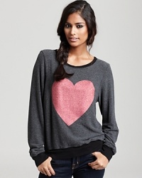 Fall in love with this slouchy-chic WILDFOX sweatshirt, featuring a sparkling glitter heart. Fall in love with this slouchy-chic WILDFOX sweatshirt, featuring a sparkling glitter heart.