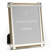 Made entirely from hand, each piece of William Yeoward Crystal draws its inspiration from antique crystal pieces originally made in England during the 18th and early 19th centuries. Traditionally styled and utterly elegant, the Classic Raffia frame is an elegant way to frame your favorite photos. Made entirely from hand, each piece of William Yeoward Crystal draws its inspiration from antique crystal pieces originally made in England during the 18th and early 19th centuries. Traditionally styled and utterly elegant, the Classic Raffia frame is an elegant way to frame your favorite photos.