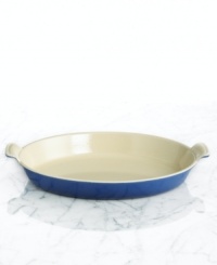 Capture the excellence of French cuisine with a refined dish that features a flat, shallow design and classic scalloped handles. Constructed of cast iron, this piece conducts and retains heat for a savory dish every time. 5-year limited warranty. Capture the excellence of French cuisine with a refined dish that features a flat, shallow design and classic scalloped handles. Constructed of cast iron, this piece conducts and retains heat for a savory dish every time. 5-year limited warranty.