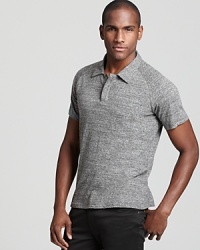 A charcoal gray cotton polo from Theory gets downtown-inspired styling with hidden front buttons and a slim fit. A charcoal gray cotton polo from Theory gets downtown-inspired styling with hidden front buttons and a slim fit.
