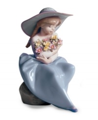 This little girl has her hands full. Admiring a cluster of beautifully colored blooms, the Fragrant Bouquet figurine is the essence of spring in glazed Lladro porcelain.