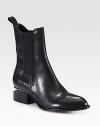 Fully commit from tip to toe in this architectural leather boot with a metal inverted heel and comfortable elastic panels. Stacked heel with metal notch, 1¾ (45mm)Shaft, 7Leg circumference, 10Leather upper with elastic stretch panelsPull-on styleLeather lining and solePadded insoleImported