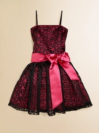 She'll be simply stunning in this lace frock with a princess-like full skirt and fancy ribbon tie.Straight necklineSpaghetti strapsBack zipperWaistband with ribbon tieFull skirtPolyesterDry cleanImported of domestic fabric She'll be simply stunning in this lace frock with a princess-like full skirt and fancy ribbon tie.Straight necklineSpaghetti strapsBack zipperWaistband with ribbon tieFull skirtPolyesterDry cleanImported of domestic fabric