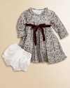 Blooming with a vivid floral print and a velvet tie, this delightful cotton frock with matching bloomers will make your little one feel like a flower girl.Ruffled round necklineLong sleevesBack buttonsWaistband with velvet ribbon tieFull skirtFully linedCottonMachine washImported Please note: Number of buttons may vary depending on size ordered. 