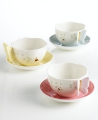 Lift this gently scalloped cup by its pastel butterfly wings and transform tea time into a sun-soaked meadow! The whimsical handle coordinates with a pale hue inside the accompanying saucer. A simple floral motif graces the cup's exterior. Lift this gently scalloped cup by its pastel butterfly wings and transform tea time into a sun-soaked meadow! The whimsical handle coordinates with a pale hue inside the accompanying saucer. A simple floral motif graces the cup's exterior.