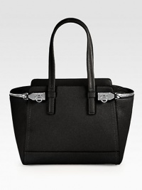 A classically chic style in smooth leather with beautifully radiant hardware.Double top handles, 7½ dropFlip-lock strap closureProtective metal feetOne outside zip pocketThree inner compartments, two open and one detachable center zip compartmentLeather lining12¾W X 9½H X 5DImported A classically chic style in smooth leather with beautifully radiant hardware.Double top handles, 7½ dropFlip-lock strap closureProtective metal feetOne outside zip pocketThree inner compartments, two open and one detachable center zip compartmentLeather lining12¾W X 9½H X 5DImported