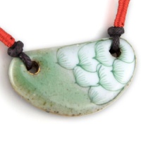 Painted Aqua Green Lotus With Fine Gold Detail - Cherry Red Woven Accents - Half Moon Crest Gray Musk Hand Made Ceramic Pendant - Dark Brown Adjustable Necklace Painted Aqua Green Lotus With Fine Gold Detail - Cherry Red Woven Accents - Half Moon Crest Gray Musk Hand Made Ceramic Pendant - Dark Brown Adjustable Necklace