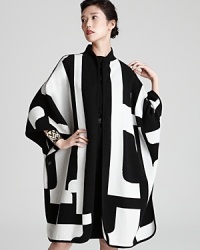 Be bold in this geometric knit Escada cape--the ultimate winter-wardrobe wow piece. Be bold in this geometric knit Escada cape--the ultimate winter-wardrobe wow piece.